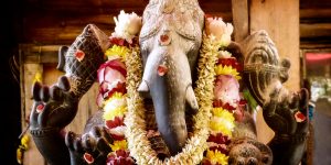 A granite murthi or statue of Lord Ganesh with flower garlands